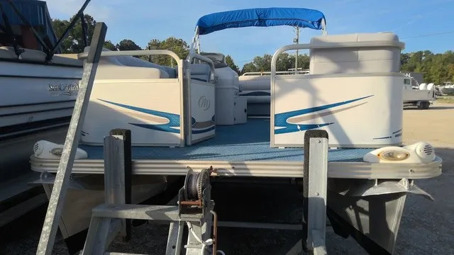 Slide: The Image of A 2008 Manitou OASIS 20 pontoon boat with a blue canopy and blue accents. - 3
