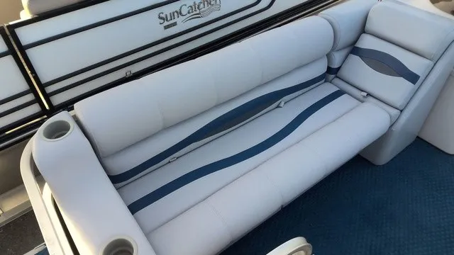 Slide: The Image of The image shows a white boat seat with blue accents and cup holders. - 7
