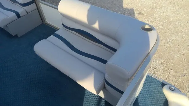 Slide: The Image of The image shows a white boat seat with blue stripes on a blue carpeted floor. - 6