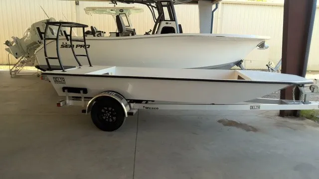 The Image of A 2027 Xplor D1660 boat on a trailer in a covered area. - 1