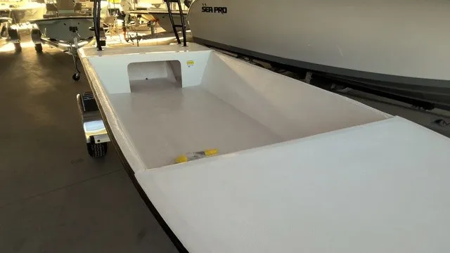 Slide: The Image of A modern, open boat with a flat deck and minimalist design, situated in a warehouse. - 2