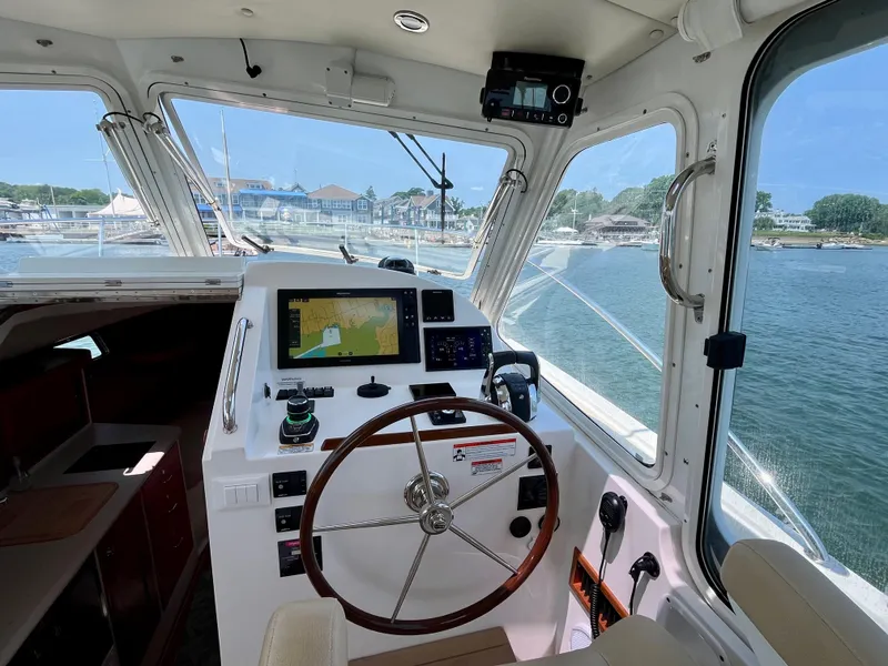 Slide: The Image of Helm of 2019 MJM 35z boat with navigation equipment, overlooking marina and water. - 26
