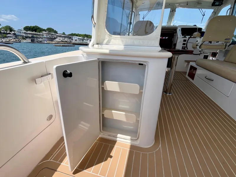 Slide: The Image of Open storage compartment on 2019 MJM 35z boat, featuring sleek interior and waterfront view. - 16