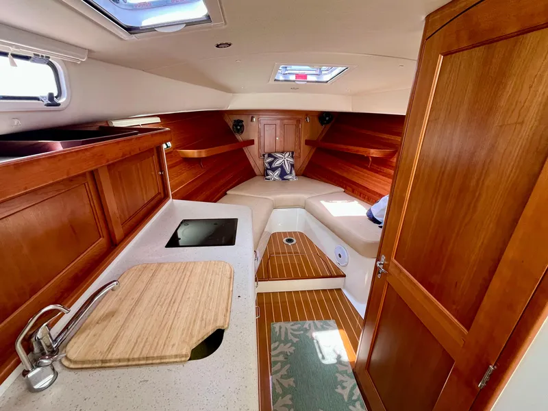 Slide: The Image of Interior of 2019 MJM 35z boat with wood finish and compact kitchen area. - 37