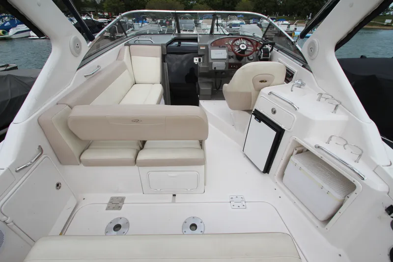 Slide: The Image of Interior of a 2011 Regal 2860 Window Express boat with seating and helm. - 12