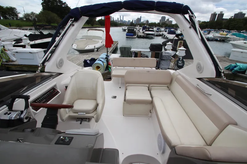 Slide: The Image of 2011 Regal 2860 Window Express boat interior with seating, docked in a marina. - 17