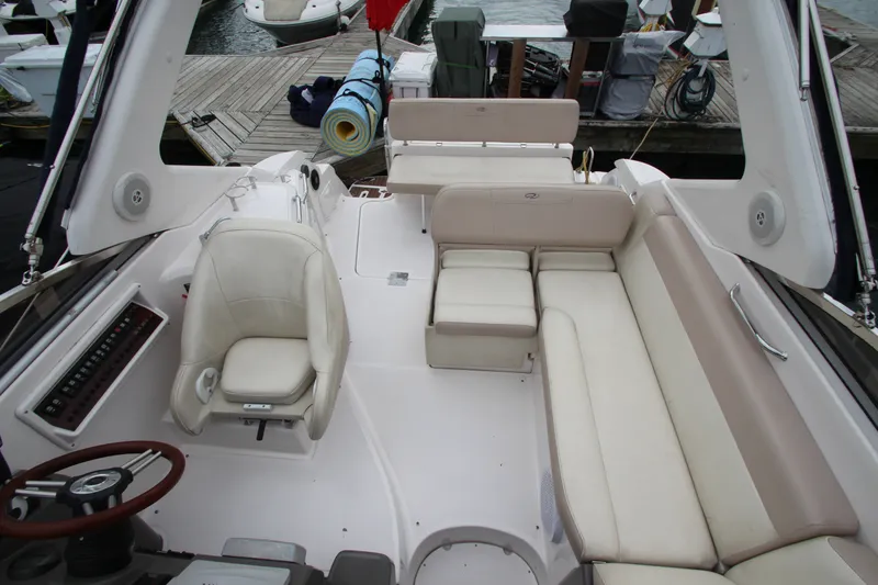 Slide: The Image of 2011 Regal 2860 Window Express boat interior with beige seating and steering wheel. - 31