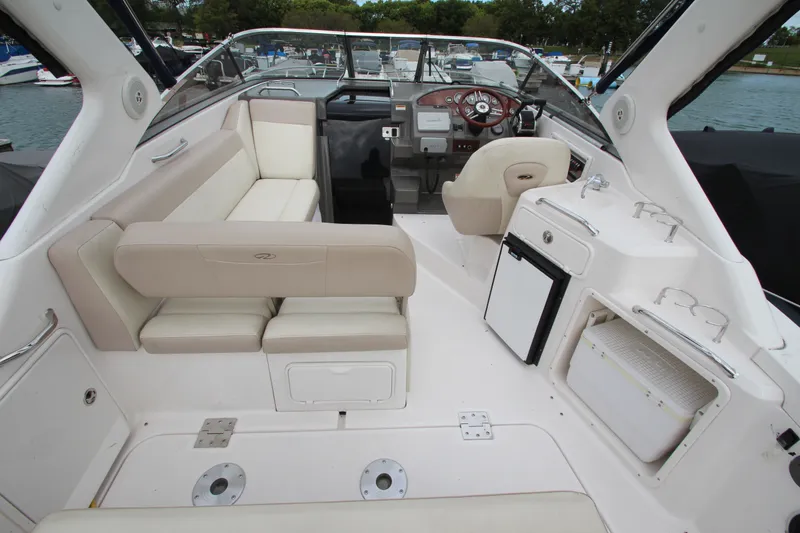 Slide: The Image of 2011 Regal 2860 Window Express boat interior with seating, helm, and amenities. - 11