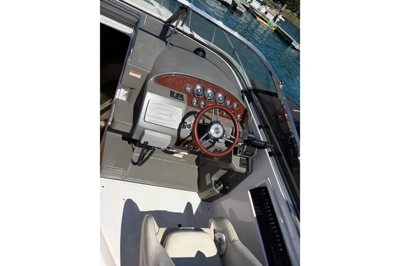 Slide: The Image of 2011 Regal 2860 Window Express boat dashboard with steering wheel and controls. - 4