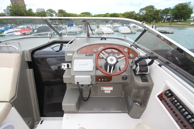 Slide: The Image of Cockpit of 2011 Regal 2860 Window Express boat with steering wheel and controls. - 26