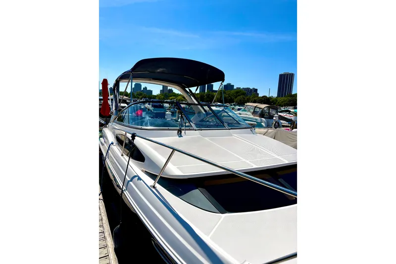 Slide: The Image of 2011 Regal 2860 Window Express boat docked in a marina under clear blue sky. - 28