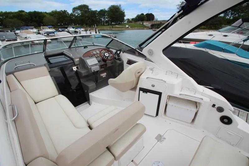 Slide: The Image of 2011 Regal 2860 Window Express boat interior with helm, seating, and docked marina view. - 19