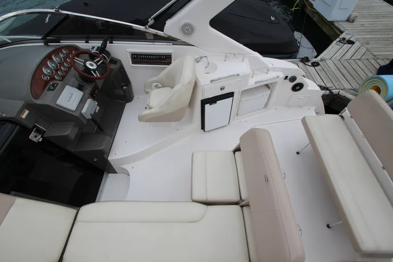 Slide: The Image of 2011 Regal 2860 Window Express boat interior with helm, seating, and dock view. - 21