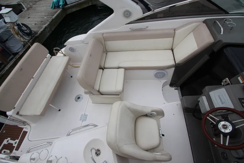 Slide: The Image of 2011 Regal 2860 Window Express boat interior with beige seating and steering wheel. - 16