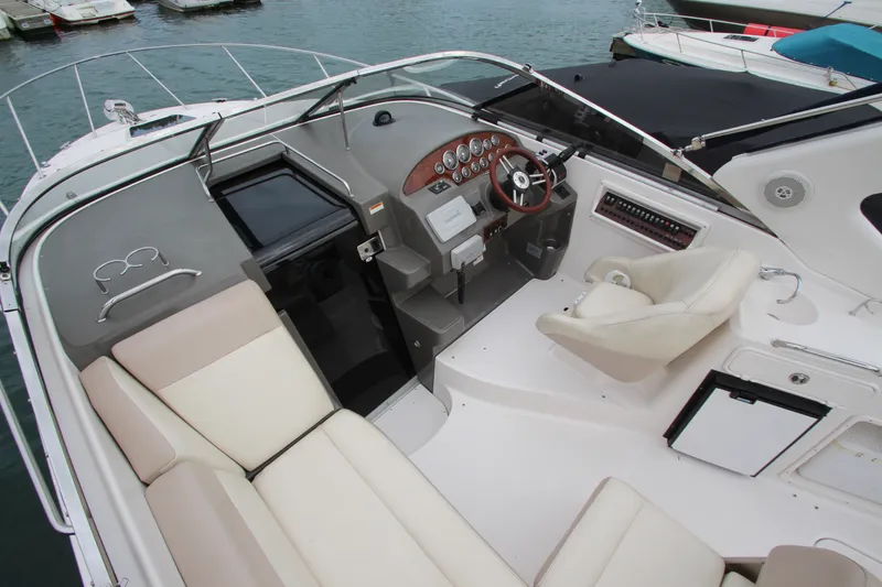 Slide: The Image of 2011 Regal 2860 Window Express boat interior with helm, seating, and dashboard controls. - 20