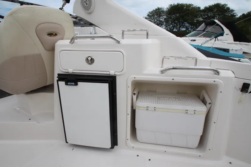 Slide: The Image of 2011 Regal 2860 Window Express boat interior with fridge and storage compartment. - 32