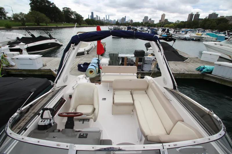 Slide: The Image of 2011 Regal 2860 Window Express boat docked, featuring spacious seating and scenic waterfront view. - 18