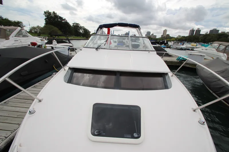 Slide: The Image of 2011 Regal 2860 Window Express boat docked at marina, overcast sky. - 10