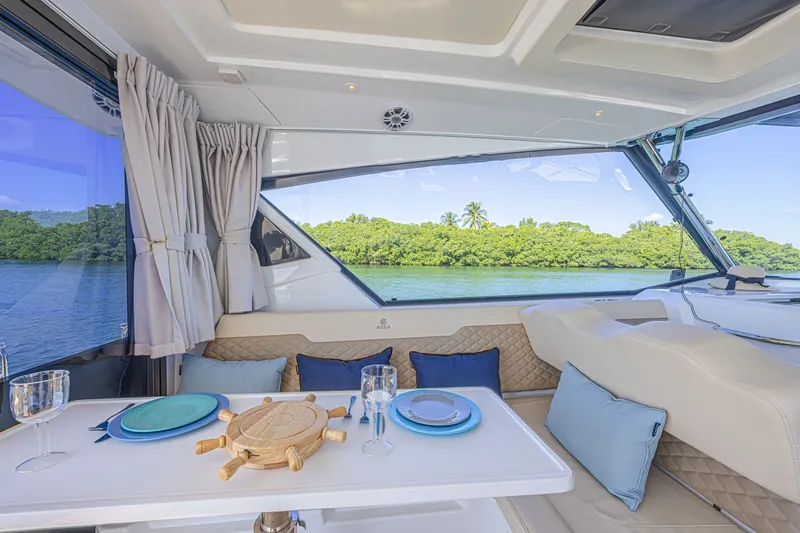Slide: The Image of Luxurious interior of 2024 Aquila 36 Sport yacht with elegant dining setup and scenic view. - 25