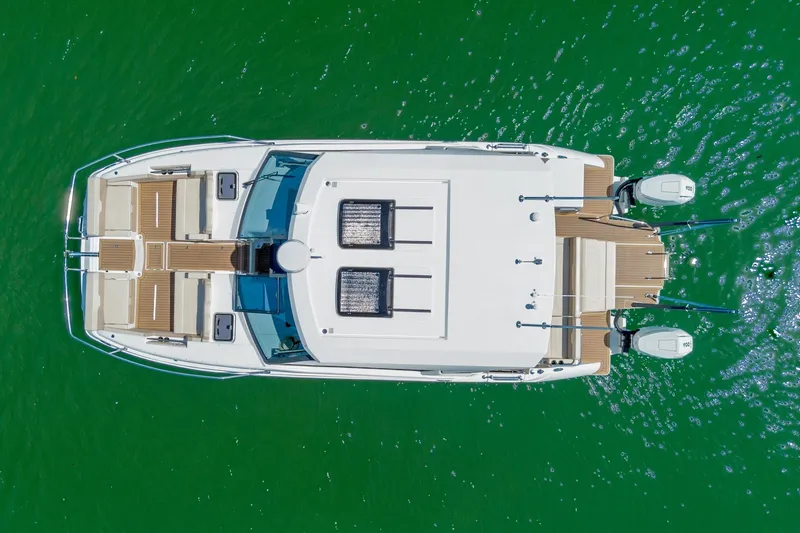 Slide: The Image of Aerial view of 2024 Aquila 36 Sport boat on vibrant green water. - 13