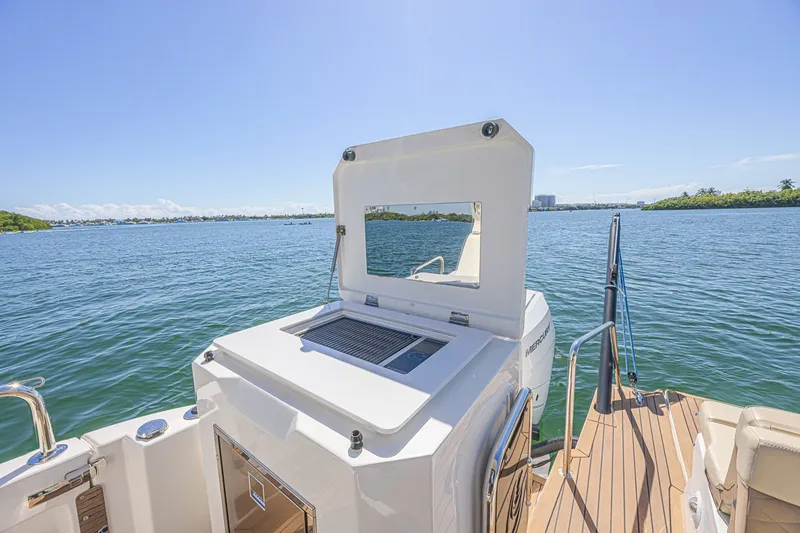 Slide: The Image of 2024 Aquila 36 Sport boat with open deck and scenic water view. - 18