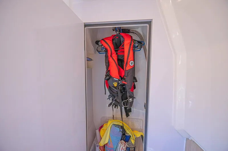 Slide: The Image of Storage compartment on 2024 Aquila 36 Sport with life jackets and towels. - 47