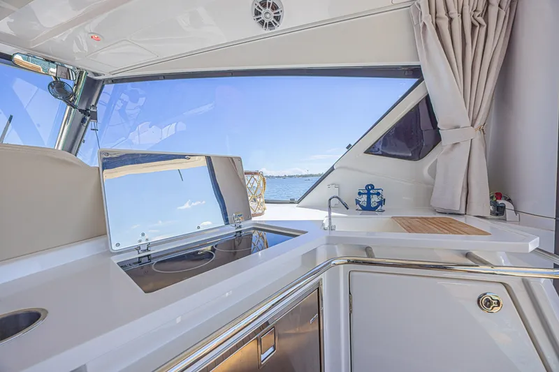 Slide: The Image of Interior view of 2024 Aquila 36 Sport yacht kitchen area with ocean backdrop. - 30