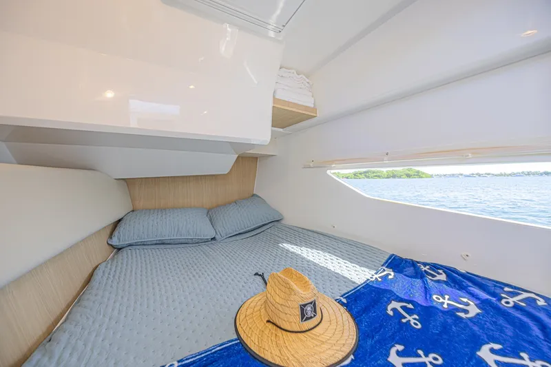 Slide: The Image of Cozy cabin interior of 2024 Aquila 36 Sport yacht with nautical decor and scenic water view. - 43