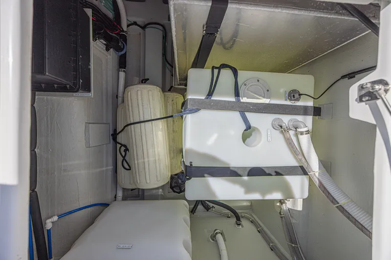 Slide: The Image of 2024 Aquila 36 Sport boat interior showing storage and plumbing components. - 50