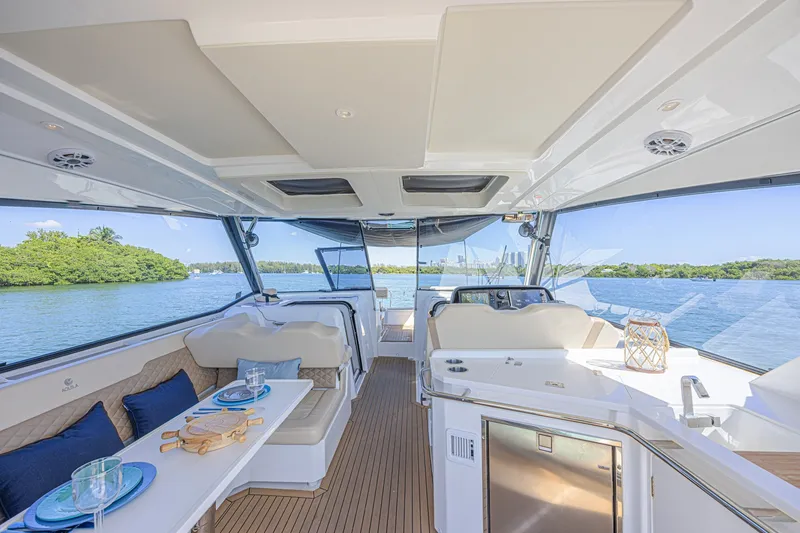 Slide: The Image of Interior of 2024 Aquila 36 Sport yacht with elegant seating and scenic water view. - 26