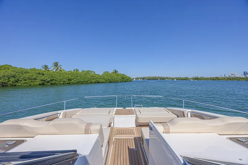 Slide: The Image of 2024 Aquila 36 Sport yacht deck with scenic water and lush greenery. - 14