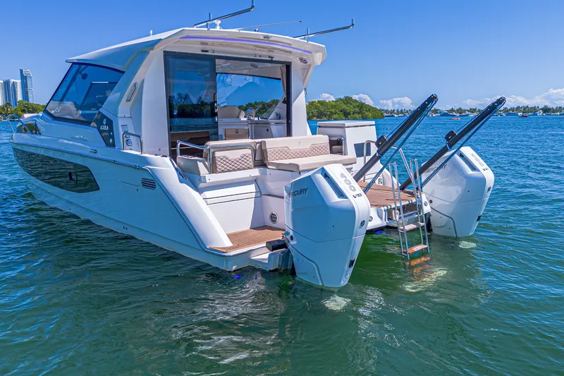 Slide: The Image of 2024 Aquila 36 Sport yacht on water, featuring dual Mercury engines and sleek design. - 7
