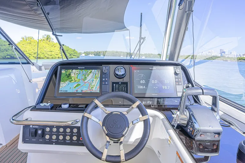 Slide: The Image of 2024 Aquila 36 Sport helm with advanced navigation displays and controls. - 35