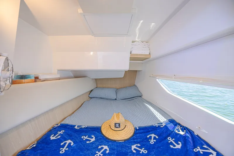Slide: The Image of Cozy cabin interior of 2024 Aquila 36 Sport with nautical-themed bedding and window view. - 42