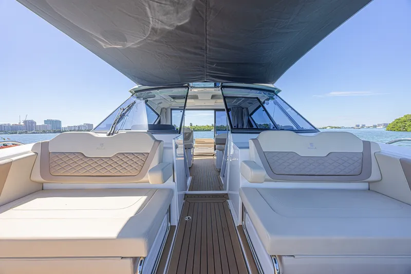 Slide: The Image of 2024 Aquila 36 Sport yacht interior with luxurious seating and scenic water view. - 22