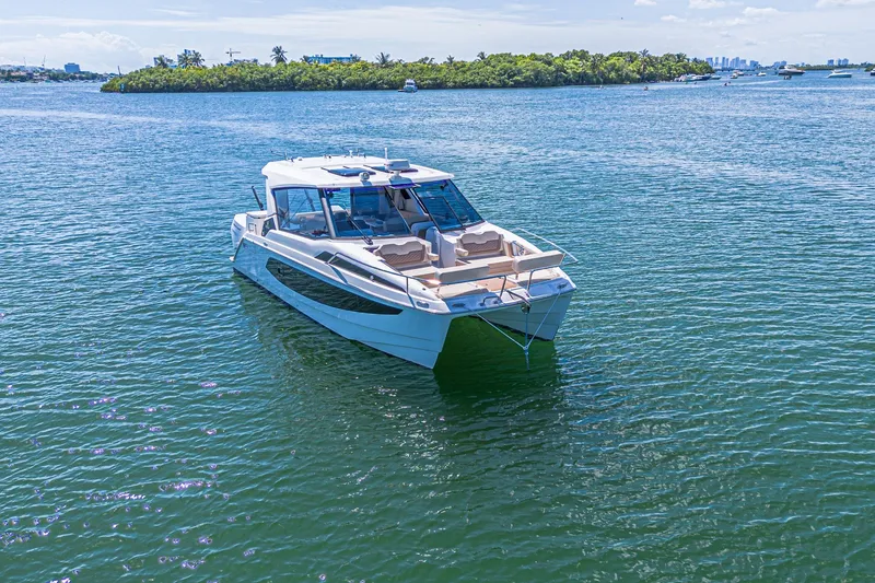 Slide: The Image of 2024 Aquila 36 Sport catamaran on serene blue waters, showcasing sleek design and luxury. - 9