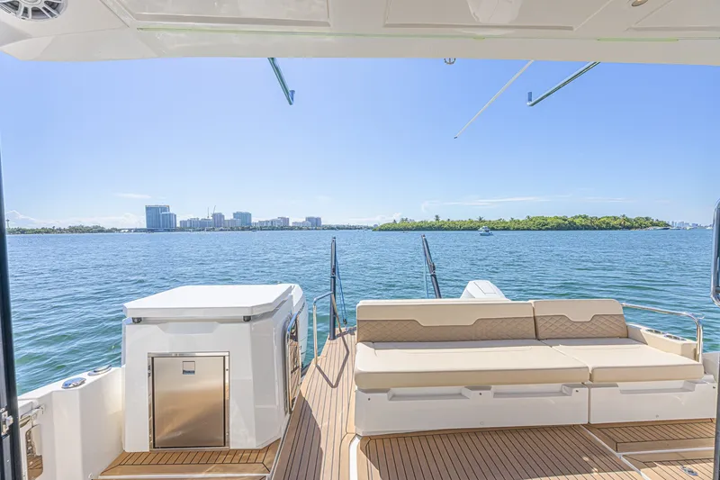 Slide: The Image of Aquila 36 Sport 2024 yacht deck with ocean view and city skyline. - 17