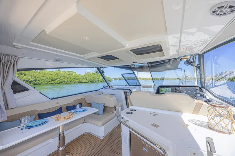 Slide: The Image of 2024 Aquila 36 Sport yacht interior with elegant seating and scenic water view. - 31