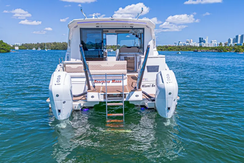 Slide: The Image of 2024 Aquila 36 Sport yacht on water, featuring dual engines and scenic city skyline. - 8