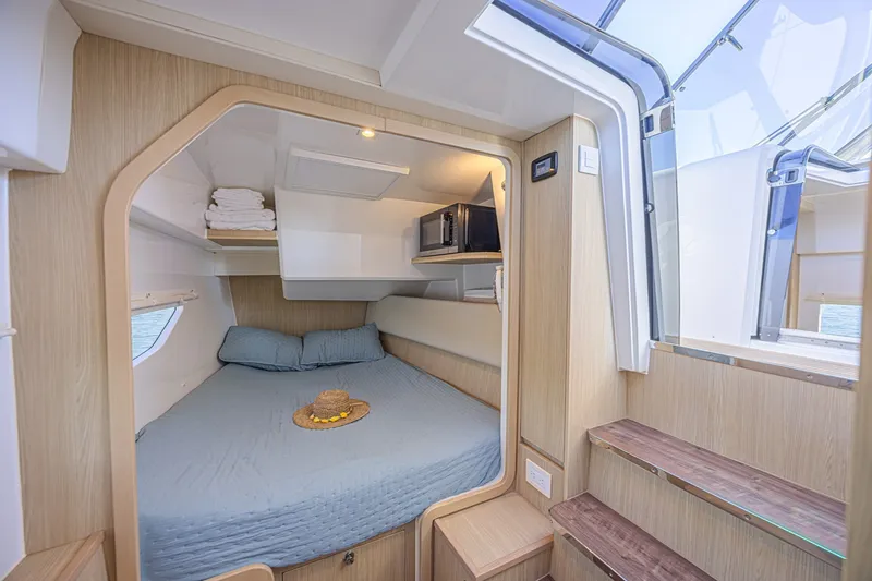 Slide: The Image of Cozy cabin interior of 2024 Aquila 36 Sport yacht with bed and wooden accents. - 38