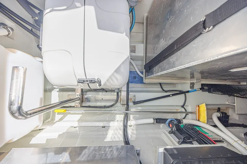 Slide: The Image of 2024 Aquila 36 Sport engine compartment with mechanical components and storage space. - 48
