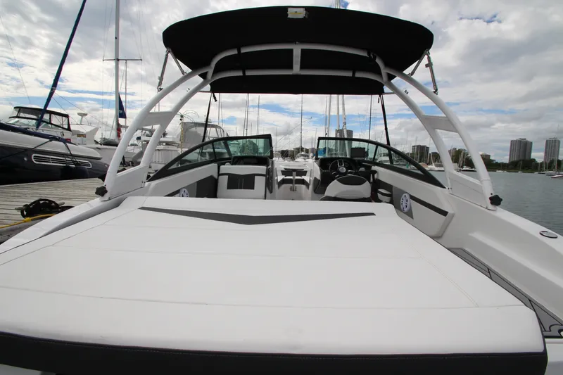 Slide: The Image of 2025 Monterey M-22 boat with sleek design docked at marina under cloudy sky. - 7