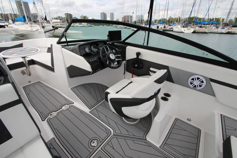 Slide: The Image of Interior of 2025 Monterey M-22 boat with modern dashboard and seating at marina. - 14