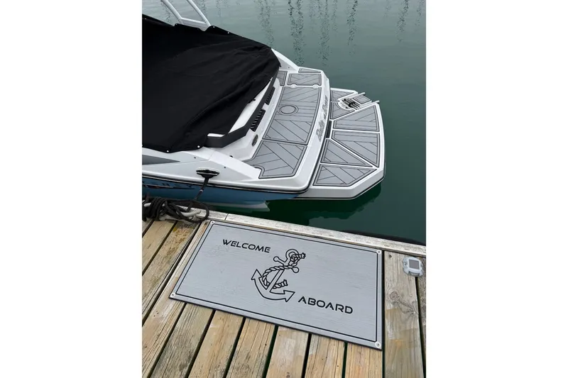 Slide: The Image of 2025 Monterey M-22 boat docked with "Welcome Aboard" mat on wooden pier. - 4