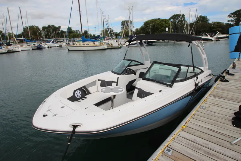 Slide: The Image of 2025 Monterey M-22 boat docked at a marina, featuring sleek design and spacious seating. - 3