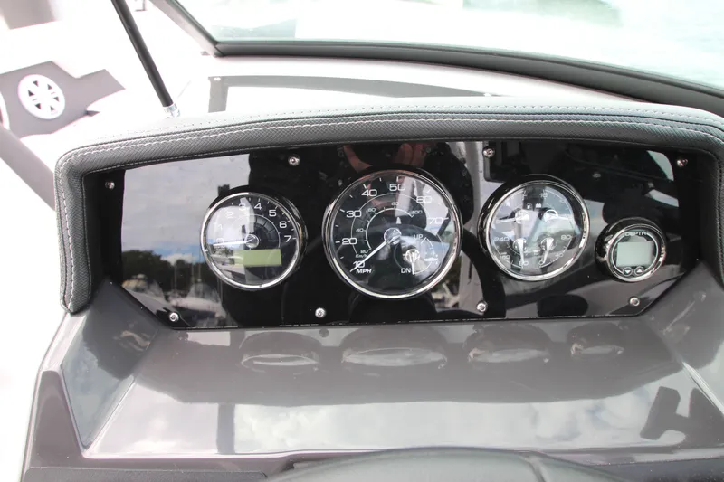 Slide: The Image of Dashboard of a 2025 Monterey M-22 boat with gauges and depth meter. - 13