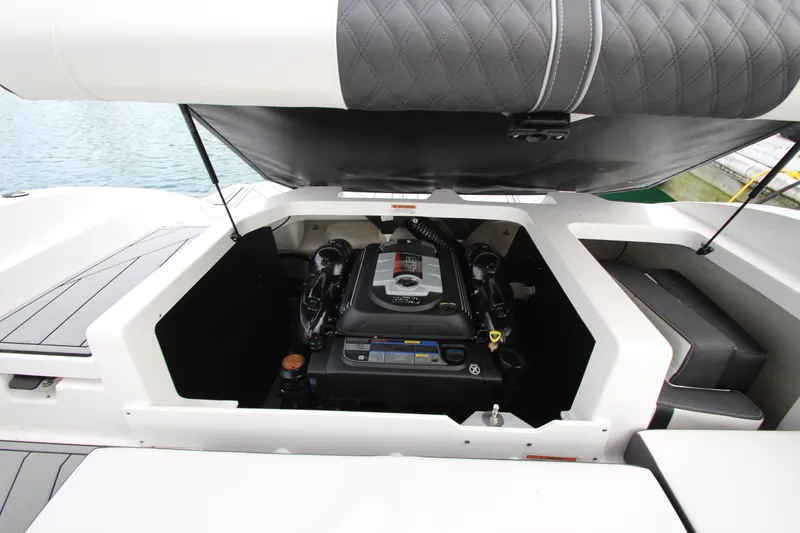 Slide: The Image of 2025 Monterey M-22 boat engine compartment with open hatch, showcasing modern design. - 21