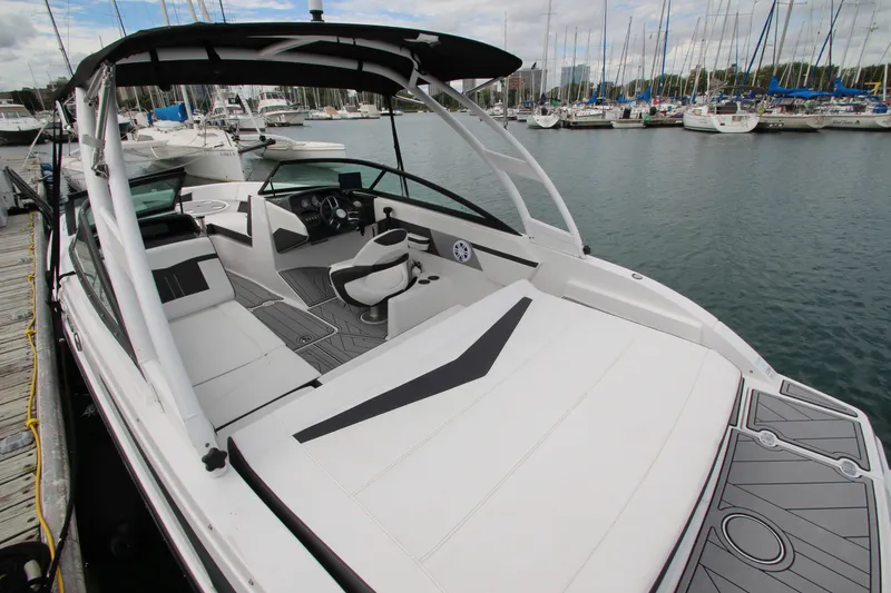 Slide: The Image of 2025 Monterey M-22 boat docked at marina, featuring sleek design and spacious seating. - 6
