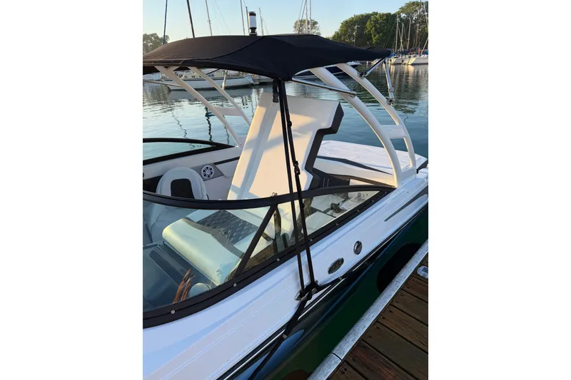 Slide: The Image of 2025 Monterey M-22 boat with canopy, docked at marina, showcasing sleek design and modern features. - 6
