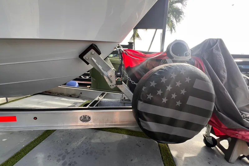 Slide: The Image of 2022 Aquasport 2300 Center Console boat on trailer with American flag tire cover. - 13